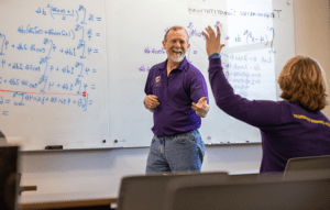 Male Mathematics professor teaching in class